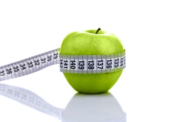 Diet concept, green apple wrapped with measuring tape