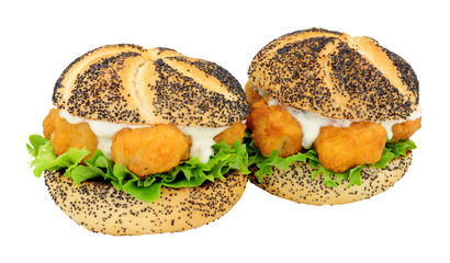 Battered cod fish nugget sandwiches with tartare sauce and lettuce isolated on a white background