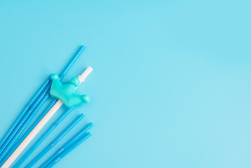 plastic straws on a blue background, copy space