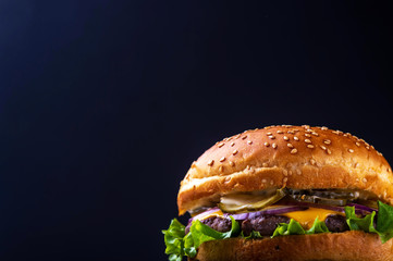 hamburger with bacon on black background