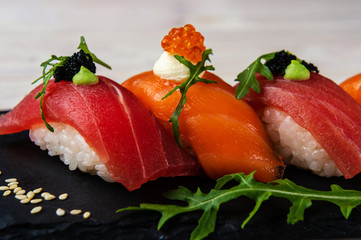 fresh sashimi with green on wooden table