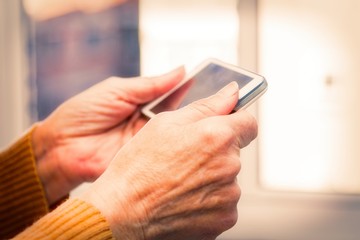 senior woman hands using cellphone