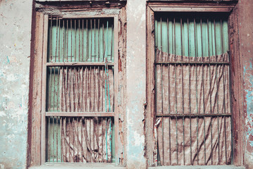 Windows with peeling paint and rust in Old Delhi India
