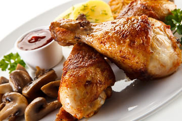 Barbecue chicken drumsticks with boiled potatoes and mushrooms