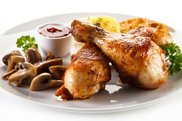 Barbecue chicken drumsticks with boiled potatoes and mushrooms