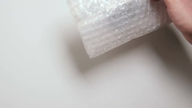  A man unpacks a parcel from China. Miniature models of figures for the board game Dungeons and Dragon. Close up. DnD Plastic gift toys.