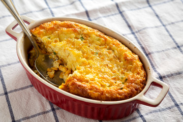 Homemade Cheddar Corn Pudding Casserole, low angle view. Closeup.