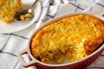 Homemade Cheddar Corn Pudding Casserole in a dish, low angle view. Close-up.