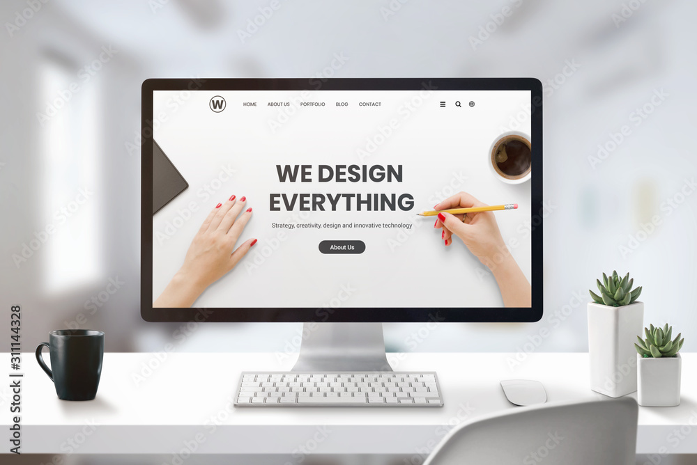 Poster Web design studio concept with modern agency web page on computer display. Office, studio desk with cup of coffee and plants beside