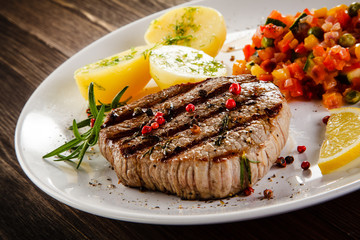 Grilled steak with boiled potatoes and vegetables