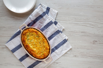 Homemade Cheddar Corn Pudding Casserole, overhead view. Flat lay, top view, from above. Copy space.