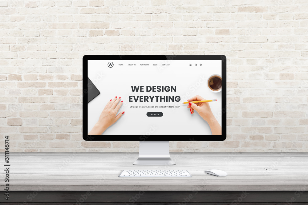 Poster Modern computer display with web design agency page on office, studio desk. Flat design concept. Modern flat design interior with brick wall in background