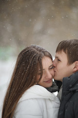 pair of lovers on a date winter afternoon in a snow blizzard