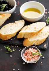 Sliced fresh crusty baguette with olive and spices