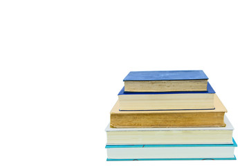 Books, stacked over one another in front of a white background