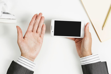 Businesswoman using her smartphone . Mixed media