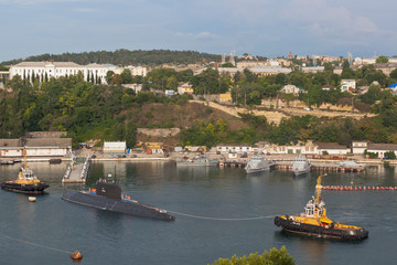 Raid tugs RB-389 and RB-412 lead a submarine from the South Bay of the Sevastopol Sea Port, Crimea