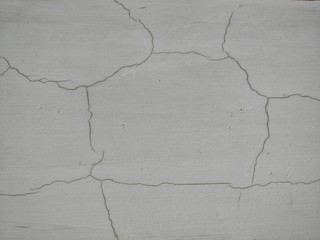 Gray concrete or plaster background with cracks