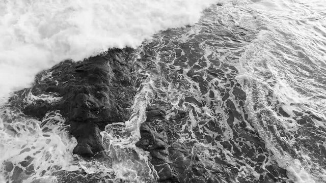 Powerful Foaming Wave Tide Against Surround on Reef Rock in Black and White Tone