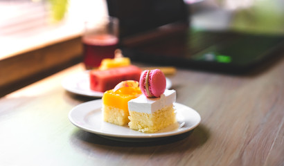 sweet cake on desk with laptop in background, copy space