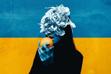 Female hand holding orange. Portrait Of Young Girl standing on color  background