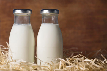 Bottle of milk on wooden background close-up. Healthy food.