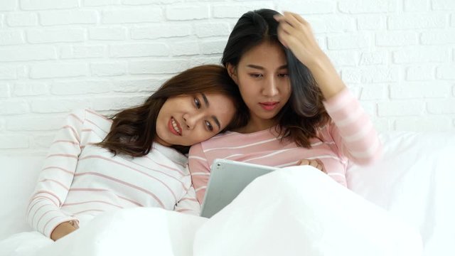 Lesbian couple homosexual happiness lifestyle on bed. Two pretty girlfriend talk, hug and laugh together relation fall in love. LGBTQ relation lifestyle concept.