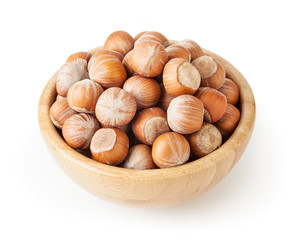 Hazelnuts in wooden bowl isolated on white background with clipping path
