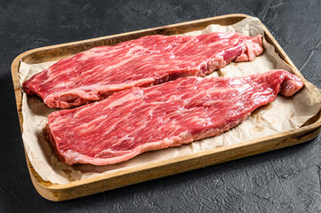 Fototapeta na wymiar Raw beef steak, flank. Marble beef. Black background. Top view