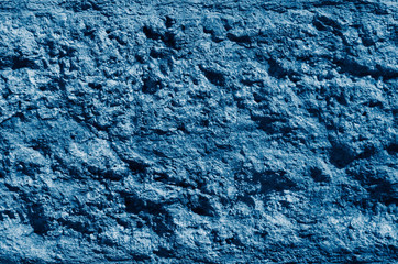 Old cracked blue color concrete wall. Textured background. 2020 color trend.