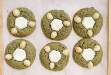 Japanese matcha green tea cookies with white chocolate and macadamia nuts on top. Top view.