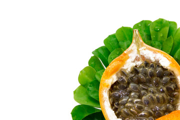 Granadilla or Grenadia passion fruit isolated on white background in composition with green leaves. Clipping path included.