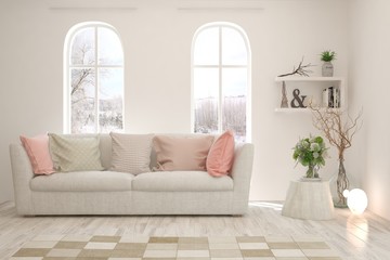 Fototapeta premium Stylish room in white color with sofa and winter landscape in window. Scandinavian interior design. 3D illustration