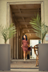 Young woman walking happily on the streets of Bucharest