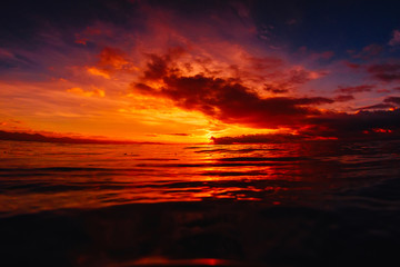 Fototapeta premium Quiet sea with warm sunset or sunrise colors. Bright sky and ocean
