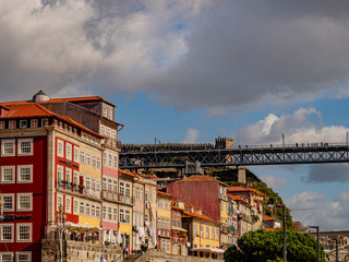Porto, Portugal. 15 November 2019. People walking on Luis I bridge above the roofs of harborfront houses.
