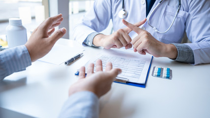 Doctor explaining and giving a consultation to a patient medical informations and diagnosis about the treatment for condition in hospital, medical ethics concept.