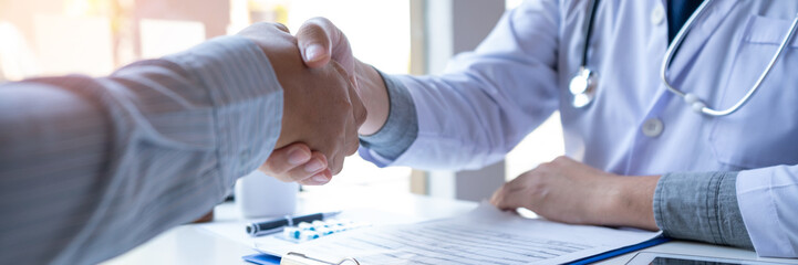 Medicine healthcare and trust concept, doctor shaking hands with patient colleague after talking...