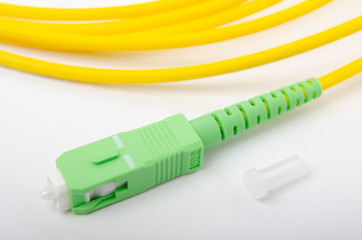 Optical SC green connector on an isolated background close-up, for connecting to the Internet, television or local area network, GPON