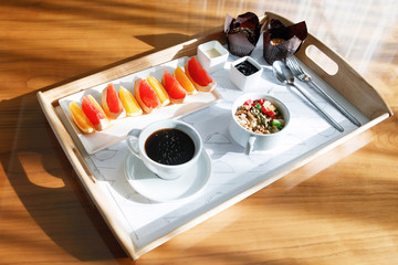 Breakfast on a wooden tray.