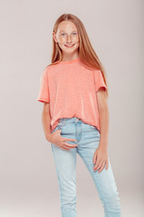 Inclusive Beauty. Girl with freckles standing isolated on grey posing to camera smiling excited