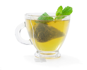 Cup of green tea with jasmine and pyramid tea bag isolated on white