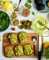 Sandwiches with avocado guacamole with pumpkin seeds and wheat seedlings. Top view.