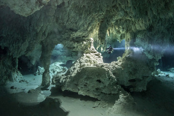 A DPV cave diver swims in the Chan hal cave (Mexico)