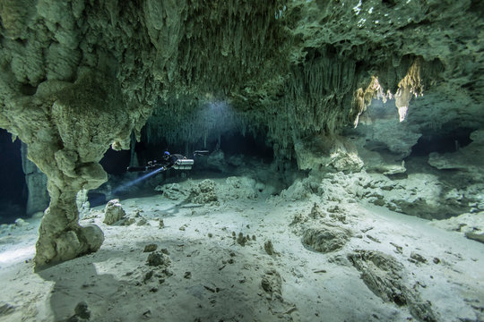 A DPV cave diver swims in the Chan hal cenote (Mexico)