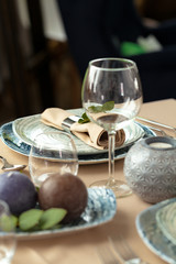 Table setting set with candles and plant branches