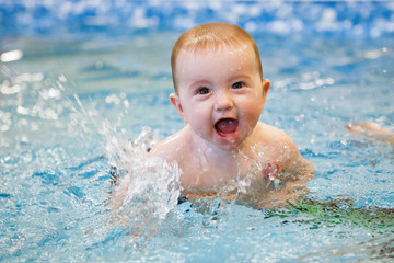 Fototapeta na wymiar Toddler swim in water pool.