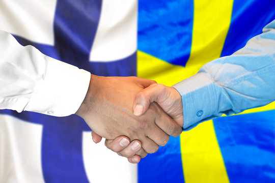 Business handshake on the background of two flags. Men handshake on the background of the Finland and Sweden flag. Support concept
