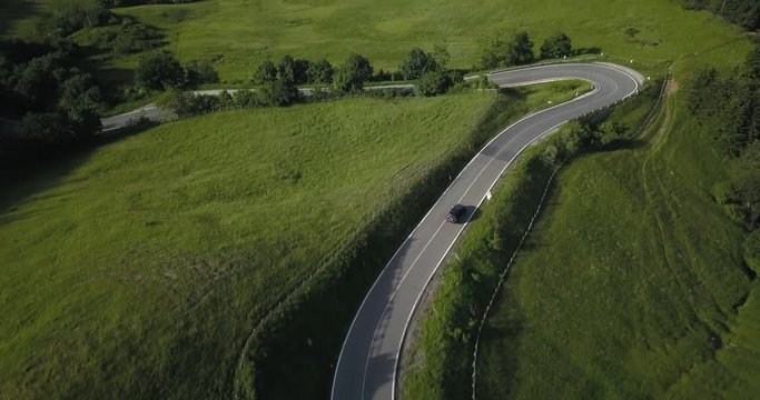 Aerial view of Mercedes driving in Passo del Giogo in Scarperia on beautiful Italian road in mountain pass