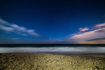 Scenic Beach at night time with stars in the sky view 